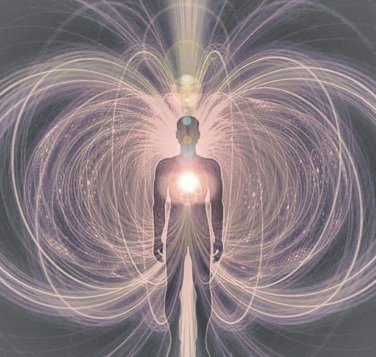 A human figure with a glowing heart, surrounded by the lines of an energy field