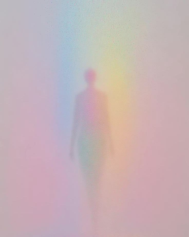The silhouette of a person in soft rainbow light