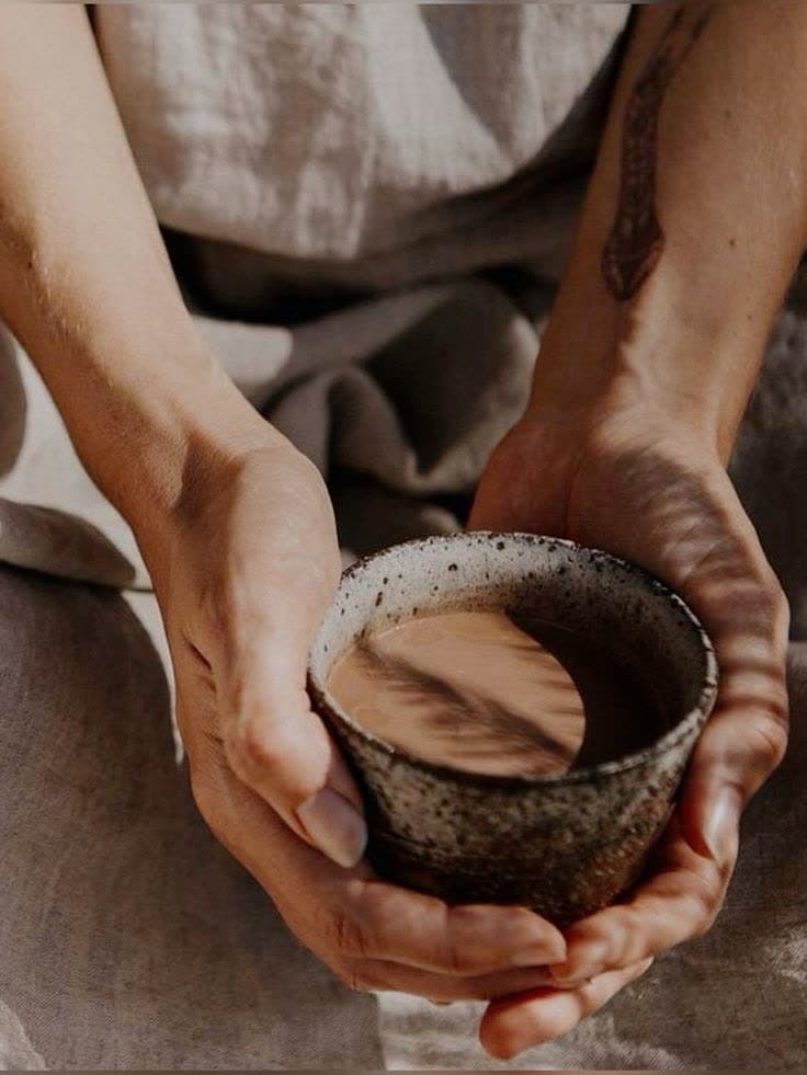 Hands holding a cup of cacao