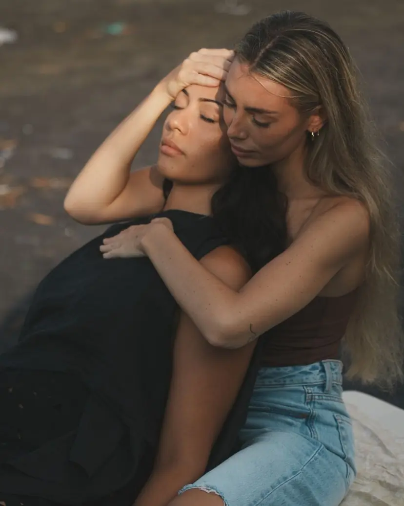 Julia holding a client from behind, a hand resting on her forehead